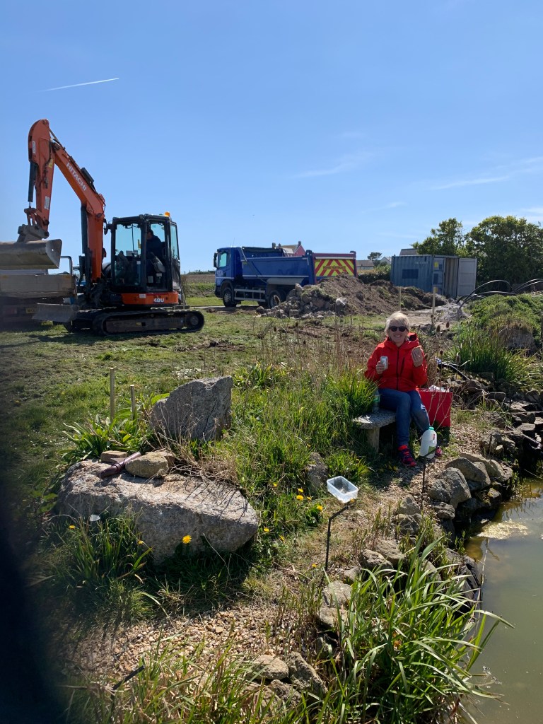 Karyn Bright sitting by pond on building site